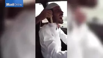 Bizarre footage shows man driving with COBRA down his shirt